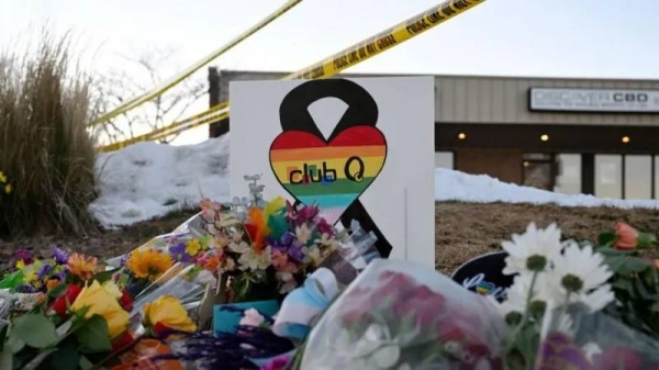 People leave flowers and other items at a memorial near Club Q where a gunman entered a nightclub killing at least five people and injuring 25 others on November 20, 2022, in Colorado Springs, Colorado