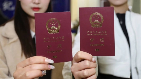 People show their passports in Huai 'an, East China's Jiangsu province in February 2023