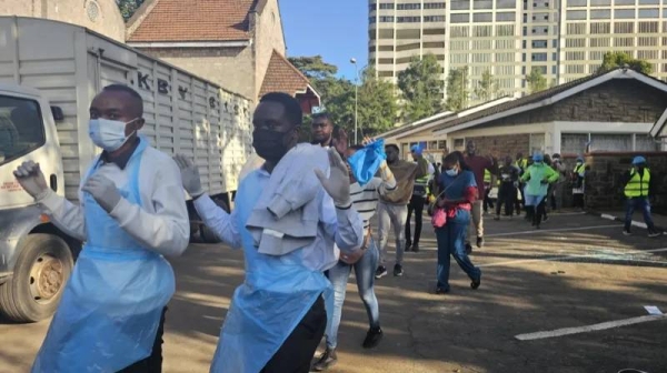 Doctors leave a medical camp they set up for protesters in a Nairobi cathedral after being forced out by military personnel