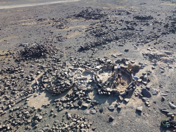 The team excavating two spaces within a single Standing Stone Circle. In the background you can see the walls of neighbouring dwellings. (Supplied)