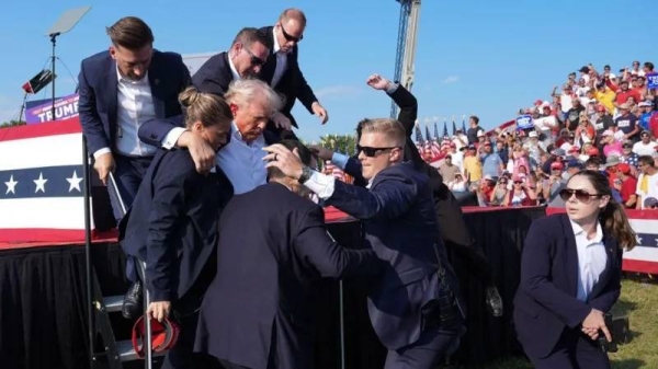 Secret Service agents immediately escorted Trump off the stage after shots rang out