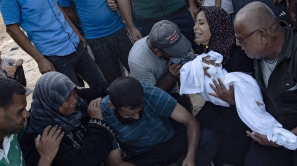 A Palestinian mother holds the body of her baby girl, who was killed in an Israeli air strike, at the Nasser Hospital in Khan Younis on July 28, 2024