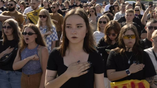 People sing the national anthem at a rally demanding the release of Ukrainian prisoners of war who are held in captivity in Russia, at Independence Square in Kyiv, Ukraine, Sunday