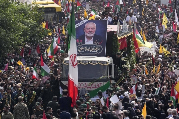 Crowds gather as the coffins of Hamas leader Ismail Haniyeh and his bodyguard are transported during a memorial service in Tehran, Iran, on Thursday.