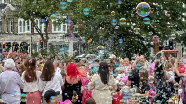 Children blew bubbles as others placed floral tributes to remember the victims of the stabbing attack