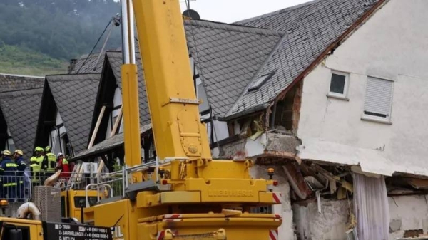 A crane is set up after a hotel partially collapsed overnight near the banks of Germany's river Moselle in Kroev, Germany, August 7