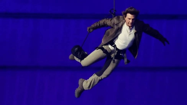 Actor Tom Cruise descended from the roof of the stadium to collect the Olympic flag, before departing on a motorcycle to begin its journey across the Atlantic