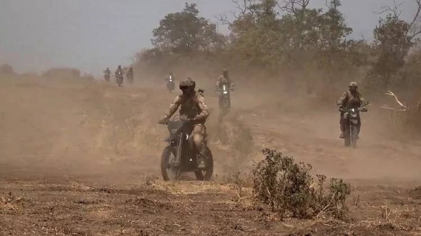 In this photo taken from video released by Russian Defense Ministry Press Service on Monday, Aug. 12, 2024, marine assault team members ride motorcycles