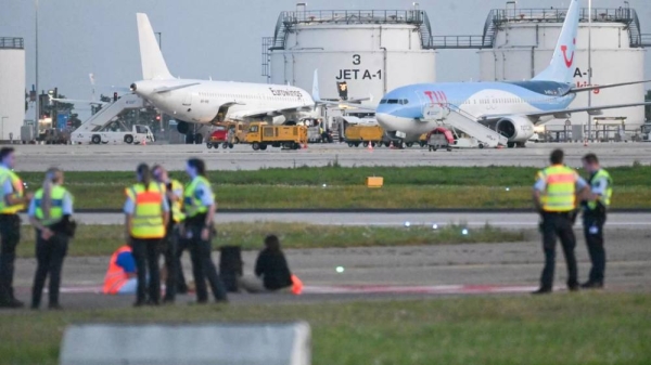 Police on the tarmac at Stuttgart airport, as climate activists staged protests at several German airports on Thursday, 15 August