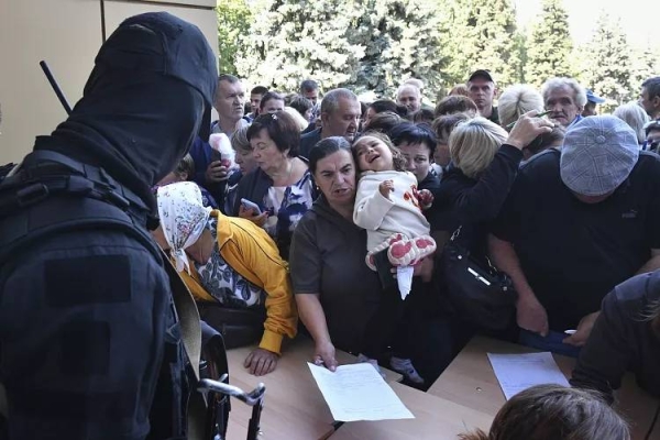 Evacuated people in the Kursk region queue to fill out the form for humanitarian aid at a humanitarian aid distribution centre in Kursk