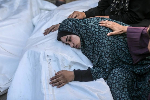 Relatives mourn over the bodies of Palestinian family members killed during an Israeli attack on Nuseirat refugee camp, after they were brought to Al-Aqsa Martyrs Hospital in Deir al-Balah, Gaza, on August 9