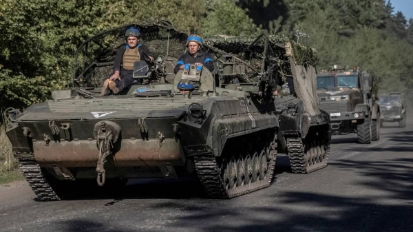 Ukrainian servicemen ride an armoured personnel carrier, near the Russian border in Sumy region, Ukraine, on Wednesday