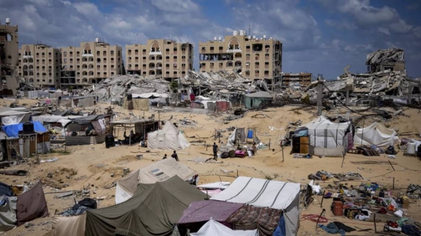 Palestinians displaced by the Israeli air and ground offensive on the Gaza Strip flee from Hamad City on Sunday, August 11