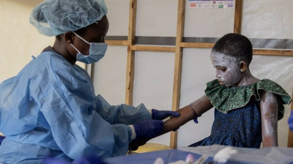 A health worker attends to a mpox patient, at a treatment centre in Munigi, eastern Congo