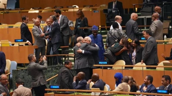 Palestinian and other diplomats celebrated after the resolution was passed by 124 votes to 14, with 43 abstentions