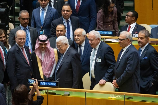 A smiling group photo of Foreign Minister Prince Faisal bin Farhan with the Palestinian delegation at the United Nations.