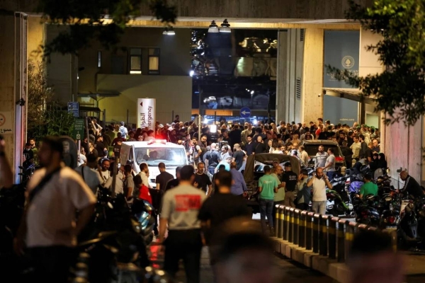 People gather outside American University of Beirut Medical Center on September 17, 2024, as people wounded in the pager attack pour in for treatment