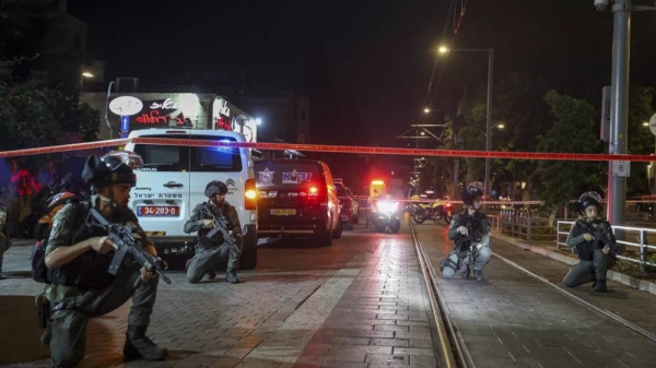 Israeli policemen take position after a shooting attack in Jaffa