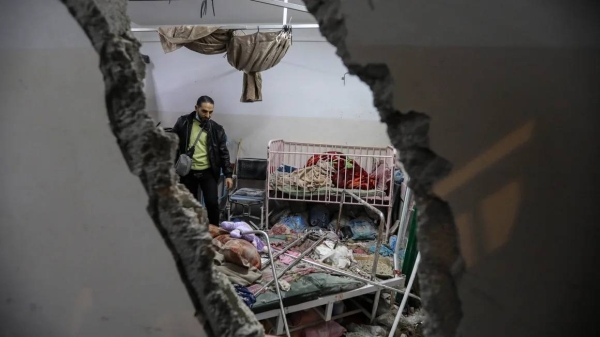 People inspect the damage caused by an artillery shell that hit the maternity hospital inside the Nasser Medical Complex, in Khan Younis, Gaza on December 17