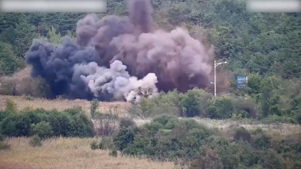 A screen grab from a video released by South Korea's Defense Ministry shows explosions along roads on the north side of the military demarcation line that separates the two Koreas.