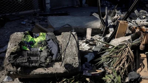 A healthcare worker's jacket lies among the rubble after an Israeli strike in Beirut