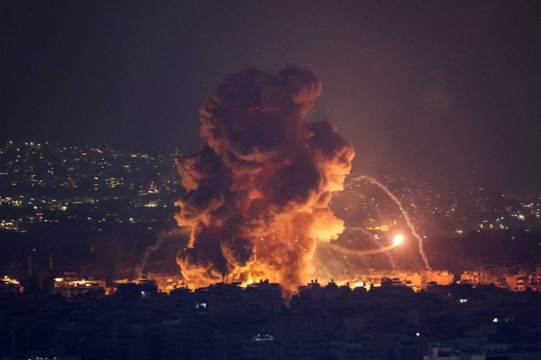 Smoke and flames rise in Beirut's southern suburbs in Lebanon after Israeli airstrikes, as seen from Sin el Fil, Lebanon, on October 6.