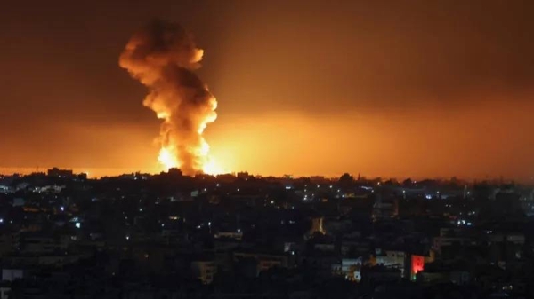 A night time image of southern Beirut, smoke is rising from a bright blaze on the skyline