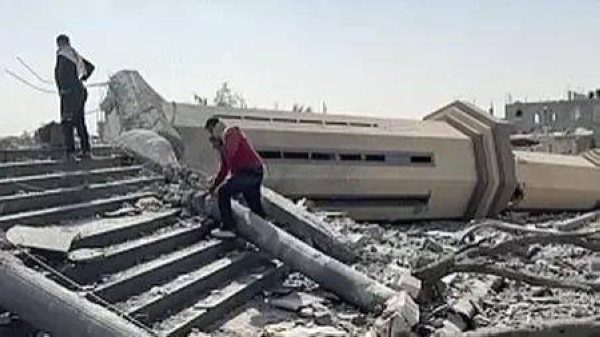 People observe a mosque destroyed by Israeli airstrikes in the city of Khan Younis, sothern Gaza Strip, Friday, Oct. 25, 2024