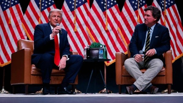 Former President Donald Trump sits down with Tucker Carlson during his Live Tour at the Desert Diamond Arena on October 31, 2024, in Phoenix, Arizona