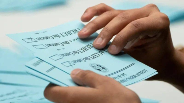 A union member from the International Association of Machinists and Aerospace Workers District 751 counts ballots after a vote on a new contract proposal from Boeing