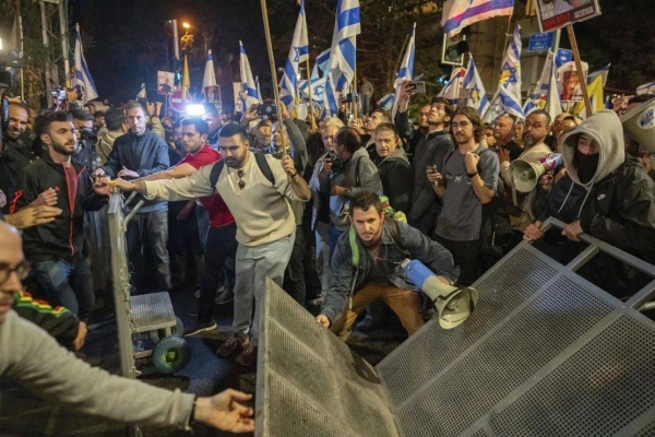 People protest near the residence of Prime Minister Benjamin Netanyahu in Jerusalem after he dismissed his defense minister Yoav Gallant in a surprise announcement Tuesday, Nov. 5, 2024