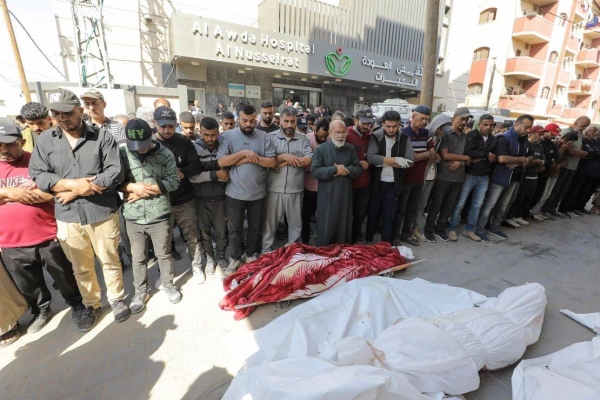 Mourners perform Janazah, the Islamic funeral prayer, in Al-Awda Hospital, after an Israeli attack on the house of the Yazici family, in central Gaza, on Thursday