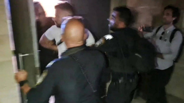 In a screen grab taken from an AFPTV video, Israeli police detain a French consulate staff officer at the French-owned Eleona church compound in Jerusalem, on November 7, 2024