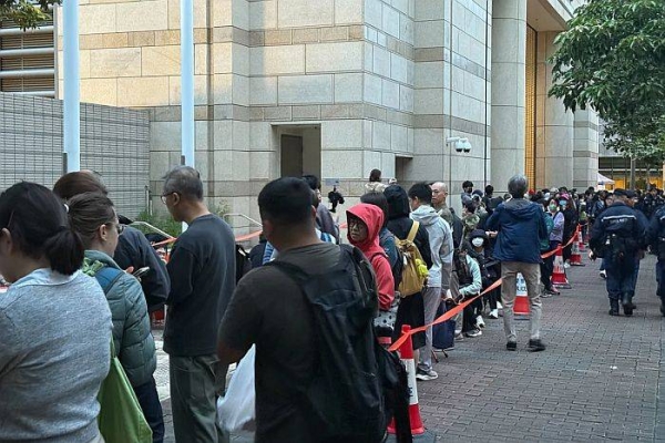 People queue outside the West Kowloon court in Hong Kong on November 19, 2024