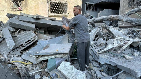 A Palestinian inspects the rubble of a building in Beit Lahia, in the northern Gaza Strip, on November 21, 2024, as the war between Israel and Palestinian Hamas militants continues