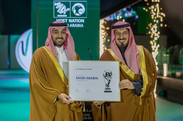 Prince Abdulaziz bin Turki Al-Faisal, Minister of Sports, and Yasser Al-Misehal, President of the Saudi Arabian Football Federation, receive the official document for hosting the 2034 FIFA World Cup.