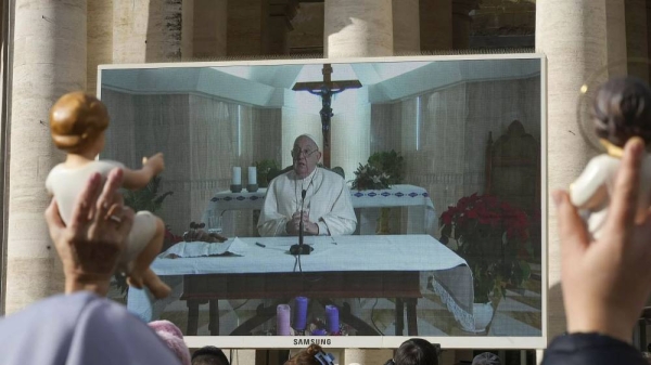 People watch the Pope’s Sunday blessing on a screen on St. Peter's Square at the Vatican, 22 December, 2024 -