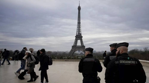 French gendarmes patrol the Trocadero plaza near the Eiffel Tower