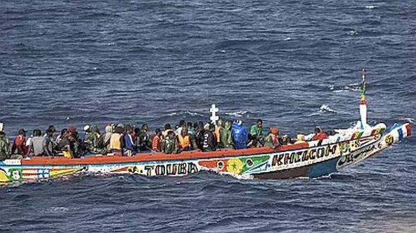 Migrants crowd a wooden boat as they sail to the port in La Restinga on the Canary island of El Hierro, Spain, Monday, Aug. 19, 2024