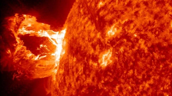 Image of solar flare from Nasa's Solar Dynamics Observatory. The flare appears as vivid red and orange. Scientists hope the probe will help us to solve some solar mysteries