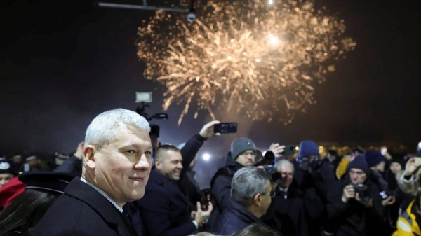 Romanian minister of Internal Affairs Catalin Predoiu amid fireworks as Romania and Bulgaria join the EU's Schengen area