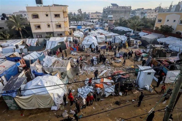 Palestinians inspect damaged tents following a strike in Deir el-Balah on 4 January which is within the 'humanitarian zone' in Gaza