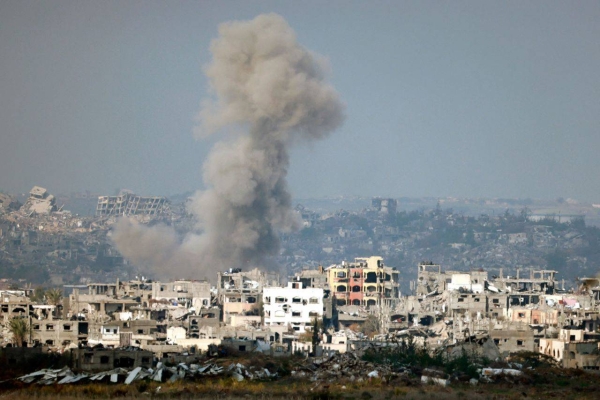 Smoke plumes rise above destroyed buildings in northern Gaza on Thursday.