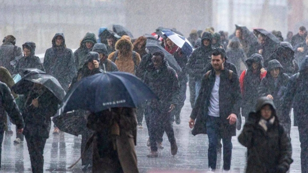 Commuters brave strong winds and rain as they cross London Bridge on Friday morning as Storm Eowyn lashes the United Kingdom