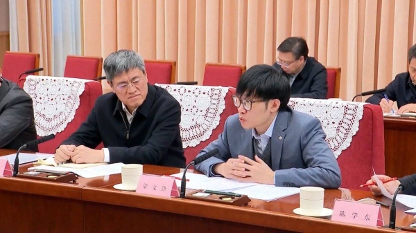 A screengrab of a CCTV broadcast shows Liang Wenfeng (R), who founded DeepSeek, speaking during a symposium in Beijing on January 20, 2025