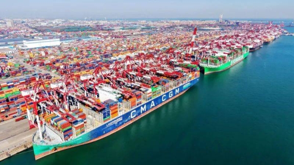 Cargo ships load and unload foreign trade containers at the fully automated terminal of Qingdao Port in China