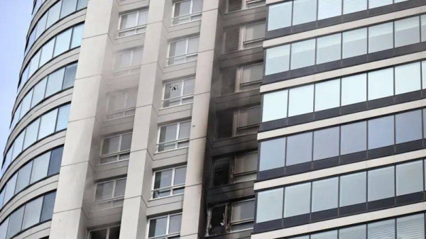 Smoke can be seen coming out of a building after dozens of people were evacuated from a 50-story skyscraper that caught fire at Puerto Madero in Buenos Aires on 11 February