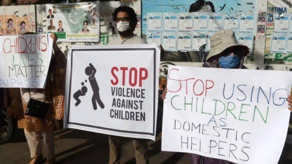 File photo of activists carrying placards during a protest against child labor