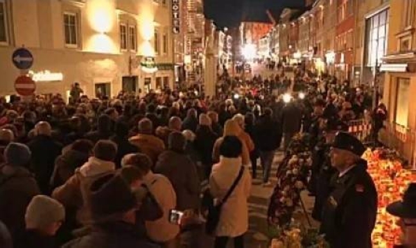 Residents of Austria's Villach attend a funeral march on Tuesday after a 14-year-old boy was killed in a stabbing attack on Saturday.