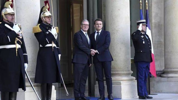 French President Emmanuel Macron greets Britain's Prime Minister Keir Starmer as he arrives for a meeting of leaders from key European Union nations in Paris